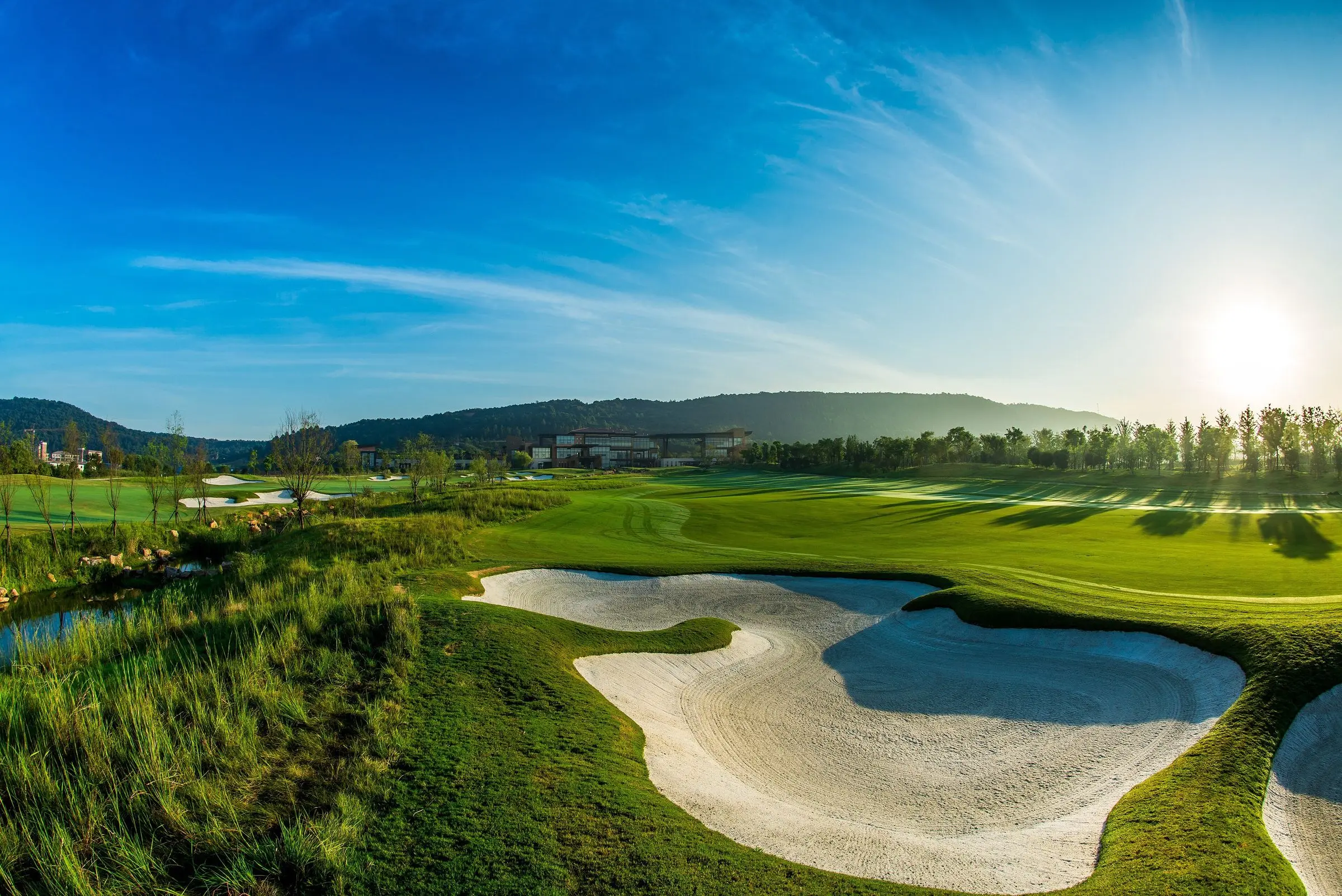 Sunlit bunkers and fairways on a bright morning